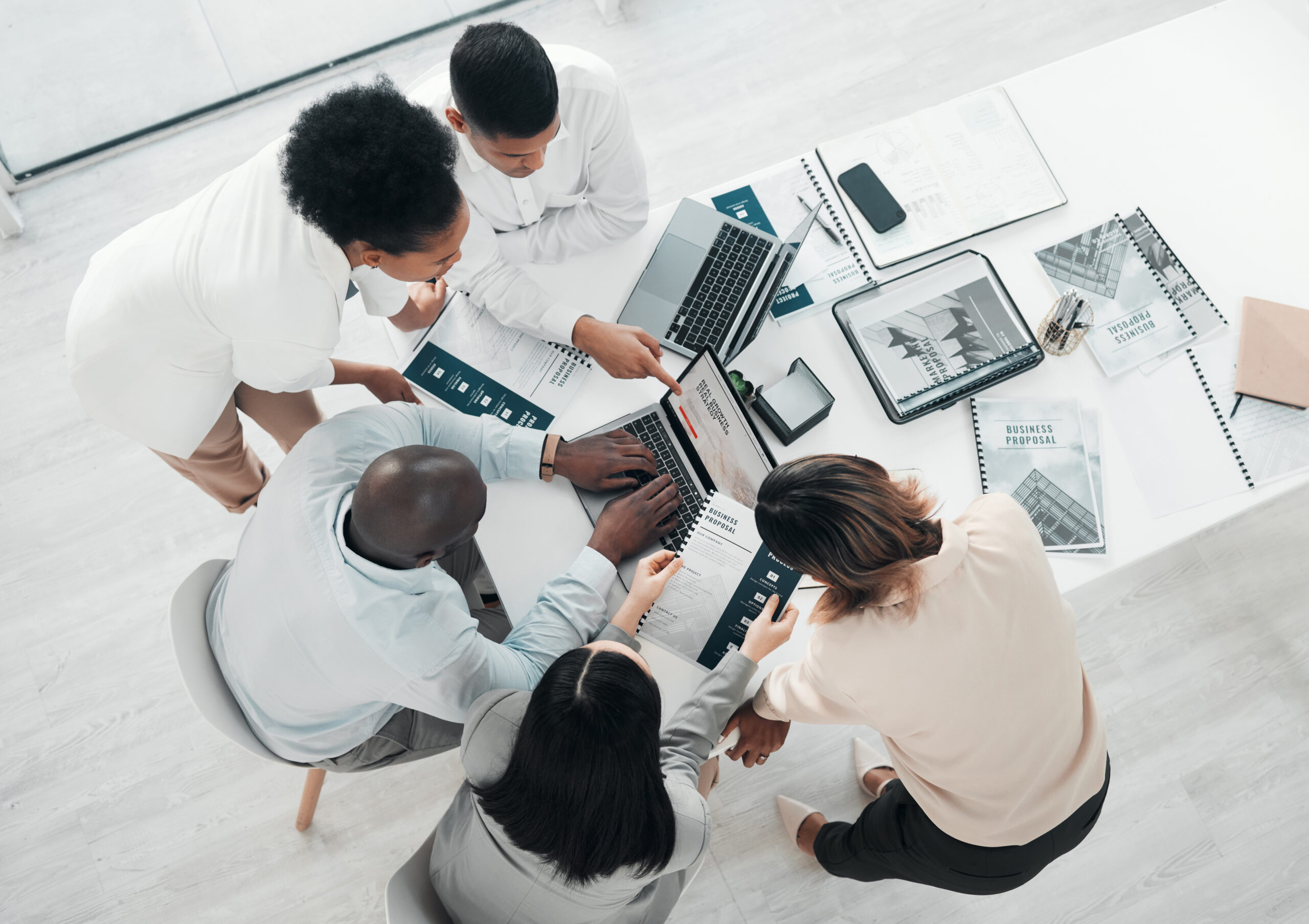 SaaS sales team discussing strategies in a meeting room.