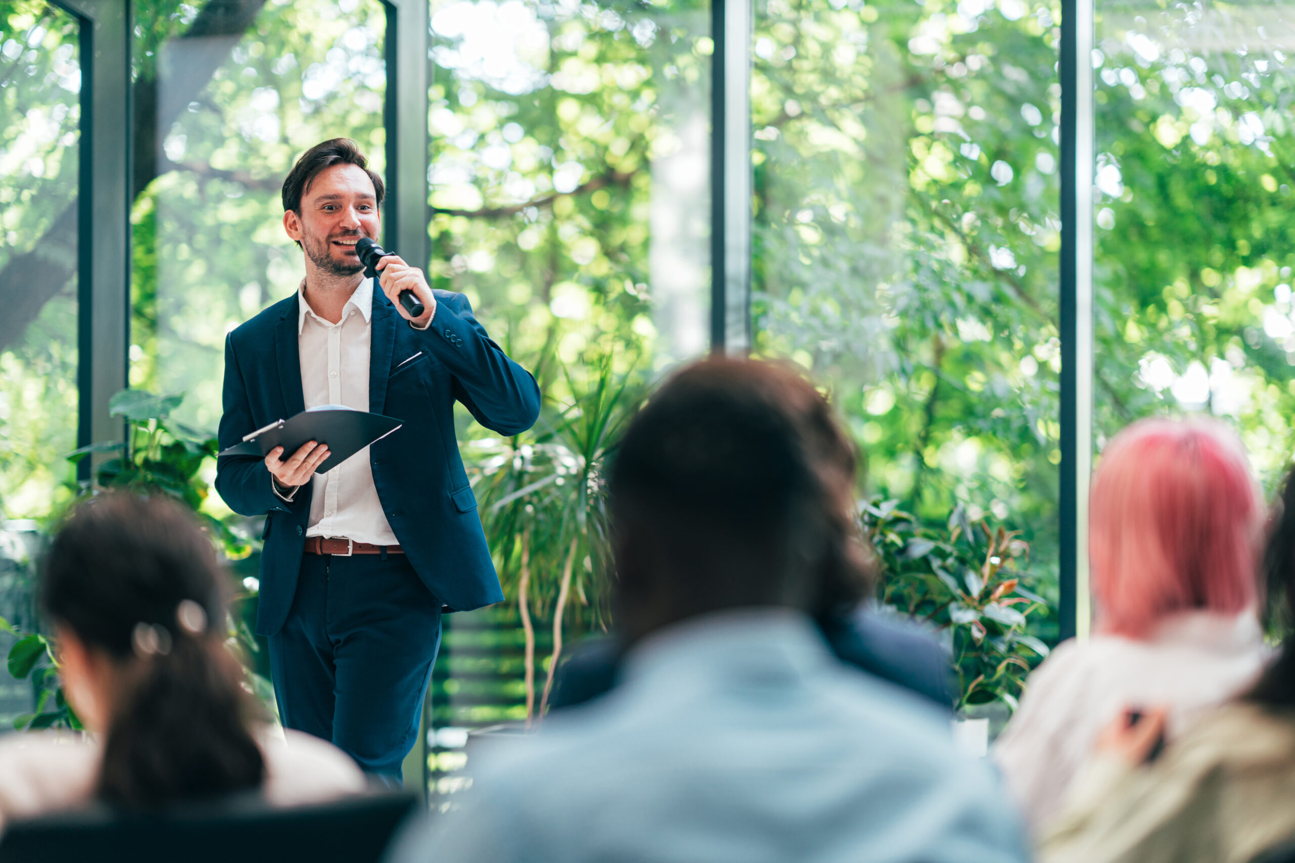 The Head of Sales in a SaaS company presenting at an industry conference, showcasing their role in building relationships with external partners and clients through events and seminars.