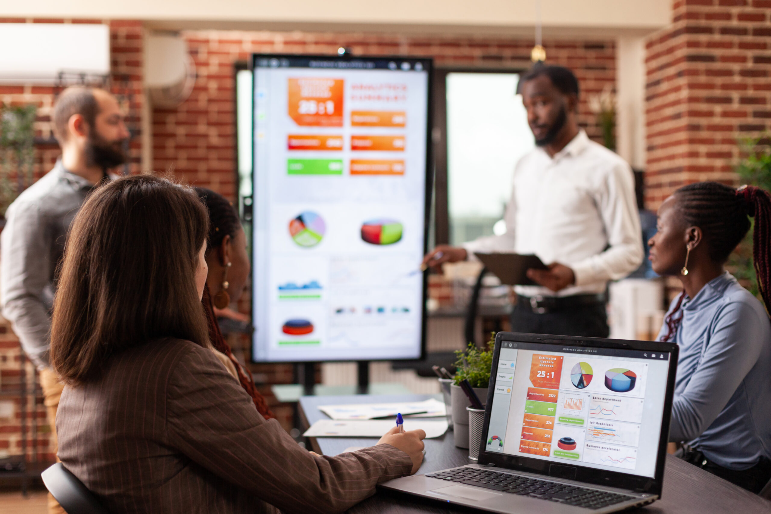 A laptop displaying a dashboard with charts and graphs, representing the tracking and analysis of SaaS sales metrics for business performance.