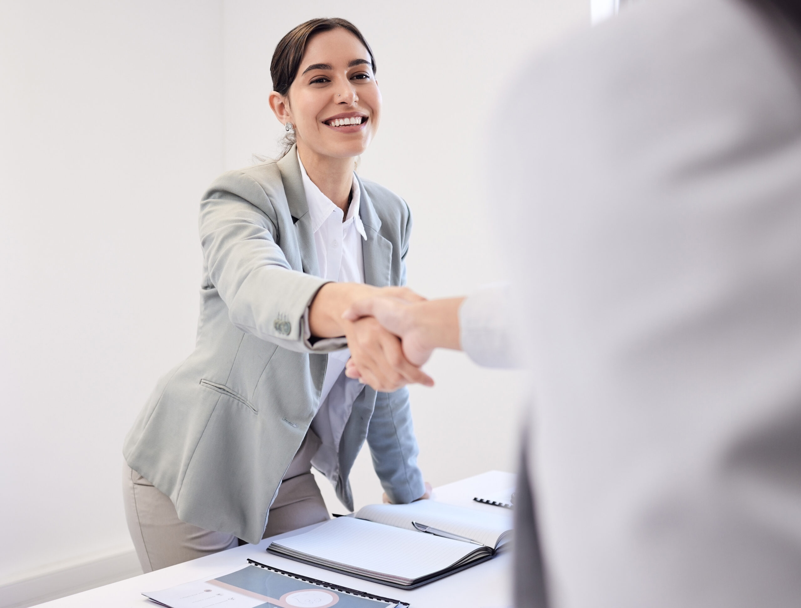 A photo depicting two SaaS professionals shaking hands in agreement, representing successful negotiations and collaboration within the software sales industry.