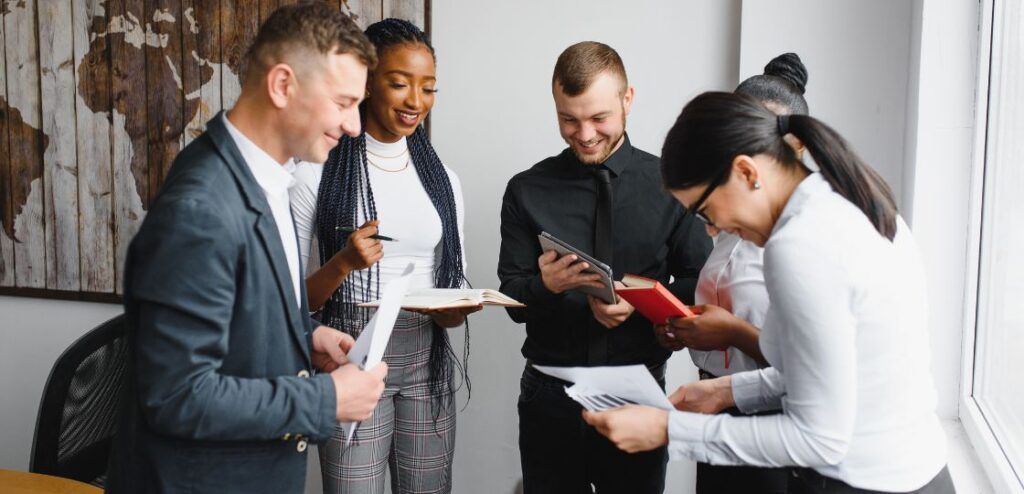 A team of recruiters discussing SaaS sales recruitment strategies in a modern office in Berlin.