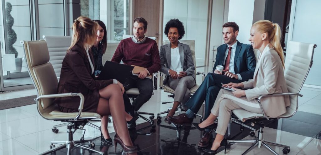 A group of professionals discussing recruitment strategies in a modern office, representing a SaaS sales recruitment agency in London.