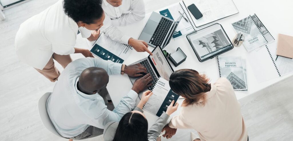 SaaS sales team discussing strategies in a meeting room.