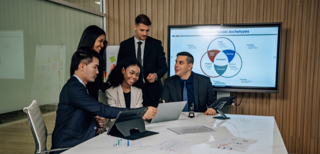 The multicultural Sales business team engages in collaborative SaaS brainstorming sessions to develop cutting-edge strategies and new business model for achieving our sales key performance indicators (KPIs).