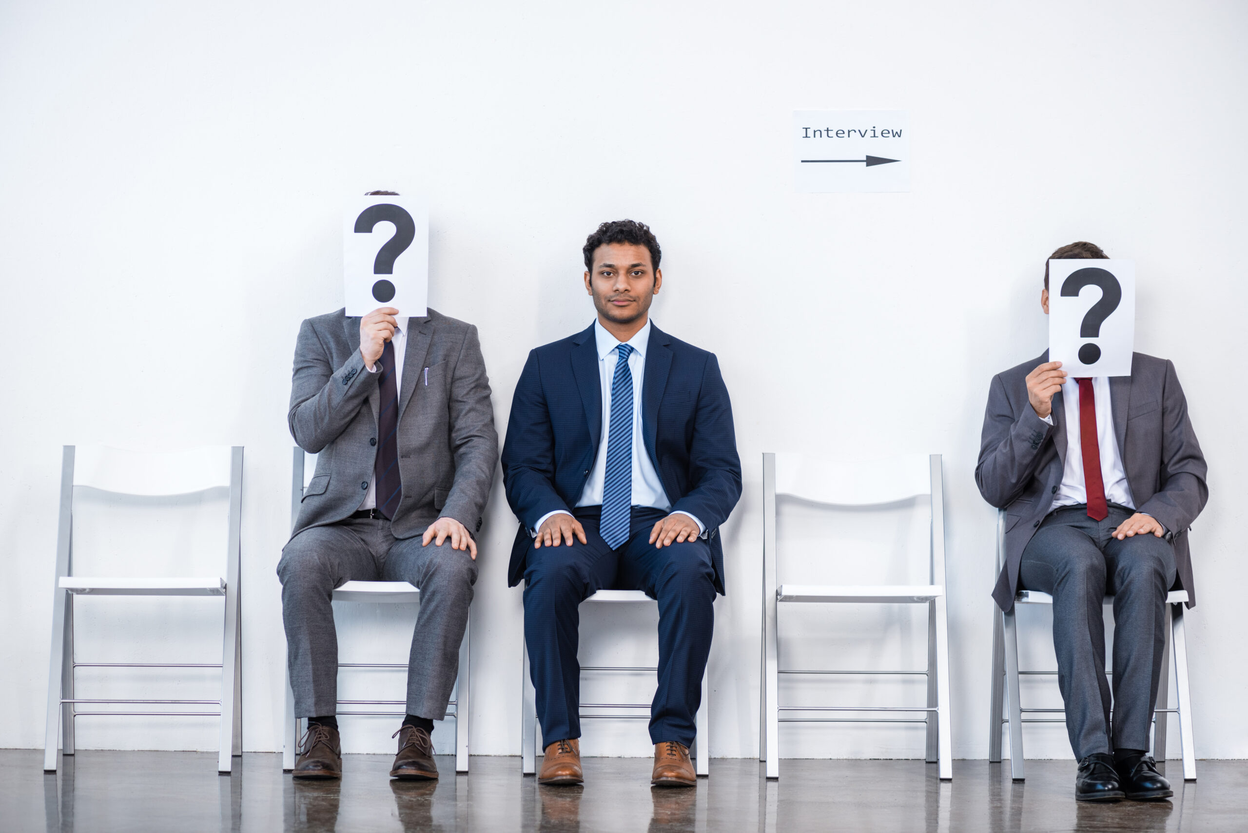 SaaS Sales people sitting in queue and waiting for interview, holding question marks in office